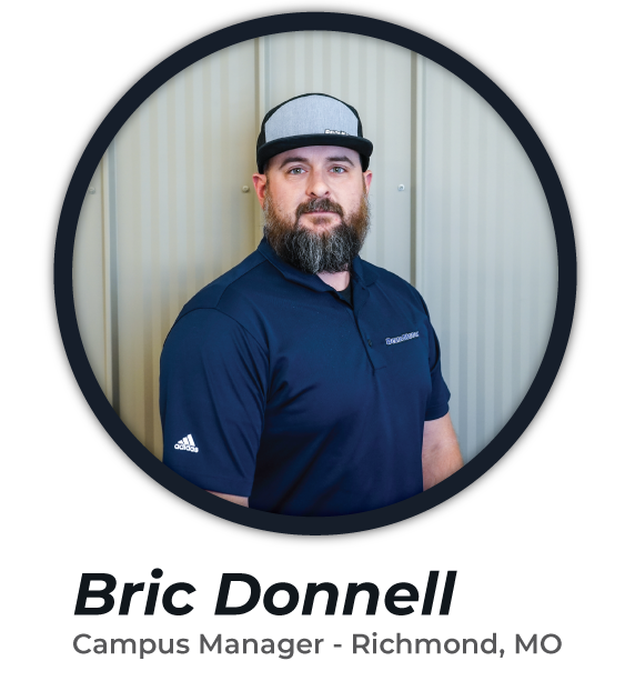 A bearded person wearing a cap and a navy blue polo shirt stands in front of a corrugated metal wall. The text below reads, "Bric Donnell, Campus Manager - Richmond, MO.